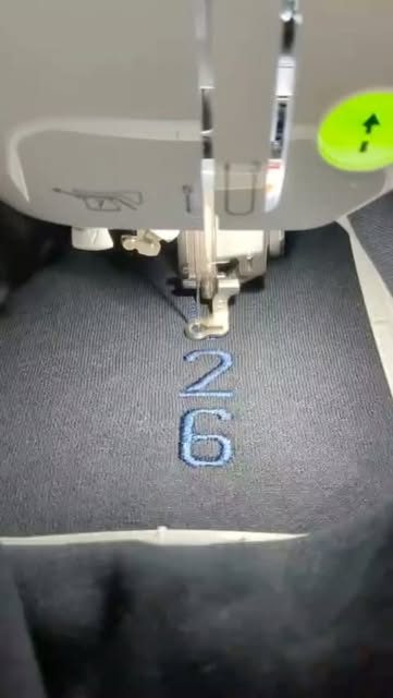 A number being embroidered onto a garment, one stitch at a time