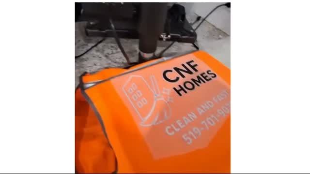 A heat-pressed logo on an orange safety vest